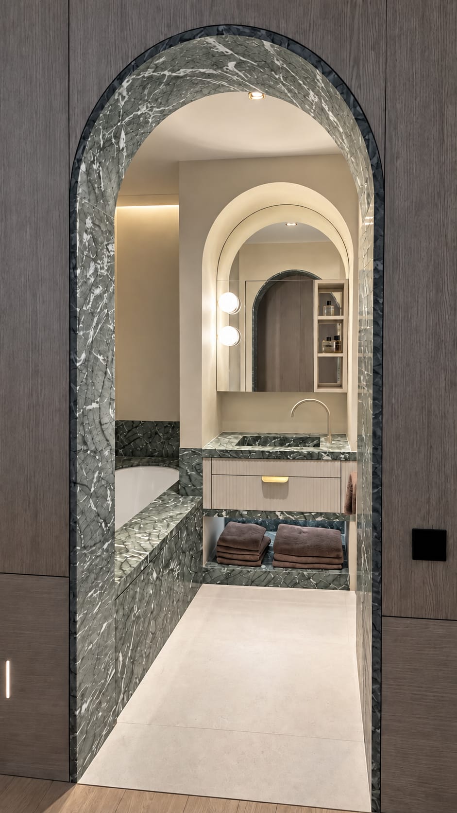 Arched bathroom entrance in Verde Antigua