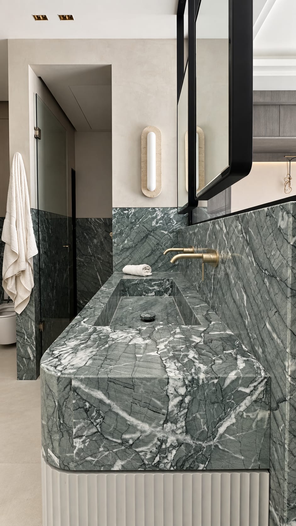 Integrated basin and wall cladding in Verde Antigua